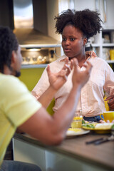 Loving man and woman enjoying in morning and eating breakfast at home.