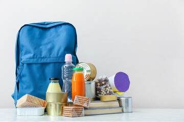 Schoolbag with different products on table. Concept of Backpack Food Program