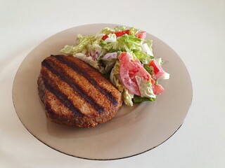 grilled meat with vegetables on the white table
