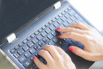 woman working with computer in work office with protective face mask