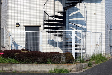A spiral staircase on the outside of an office building in Tokyo.