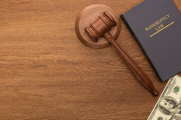 top view of money, bankruptcy law book and gavel on wooden background - obrazy, fototapety, plakaty