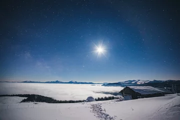 Fotobehang View at the starry sky over snowy hills. Location place Carpathian mountains, Ukraine, Europe. © Leonid Tit