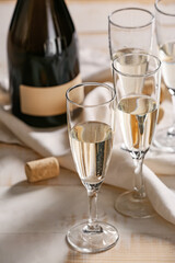 Glasses of tasty champagne and bottle on table