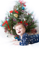 infant near christmas tree new year