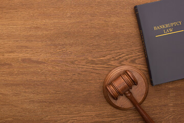 top view of bankruptcy law book and gavel on wooden background