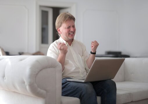 
happy man with computer at home
