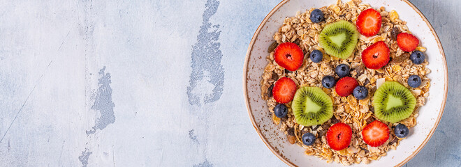 Healthy breakfast, bowl with oat granola and berries.