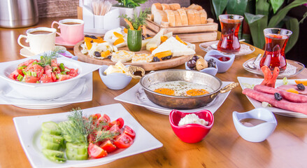 turkish breakfast table, tomato dish, cheese plate, tea, egg in the pan