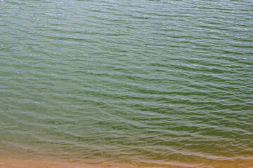 The appealing view of a pond with ripples on the surface of the water
