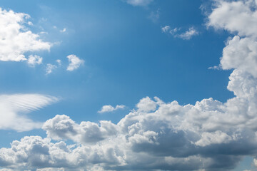 may blue sky with fluffy cumulus rain clouds
