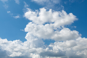 may blue sky with fluffy cumulus rain clouds