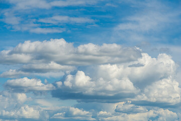may blue sky with fluffy cumulus rain clouds