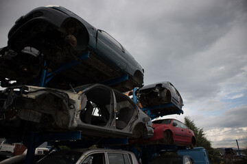 A car graveyard, with damaged vehicles, one on top of each other, which awaiting recycling or dismantling, Kozani, Greece.
