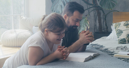 Father and daughter praying together