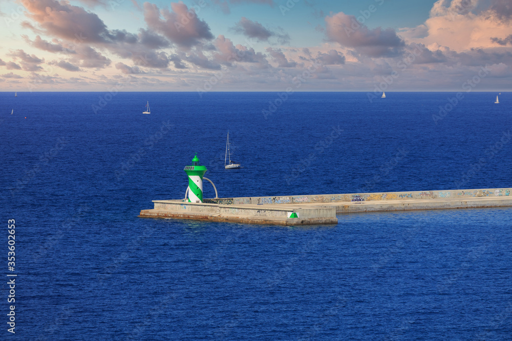 Canvas Prints green and white lighthouse at end of barcelona seawall