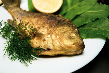 Fried crucians in a pan. Cooking fried fish. A dish of fried crucian carp. Tasty river fish.