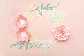 Flat lay of paper flowers on pastel pink background. Summer fashion and trendy frame