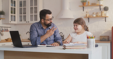Fototapeta premium Daughter studying at home with his father