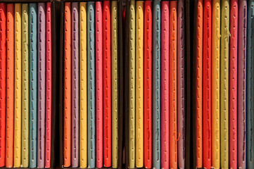 Colorful notebooks on the shelf at bookshop
