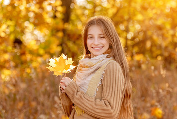 Funny girl with autumn leaf