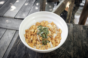 healthy breakfast fruit bowl with corn flakes and mixed seeds