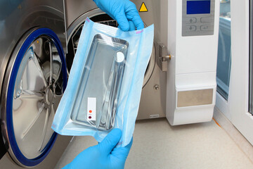 Dental instruments in a sealed bag with markers. Markers change color after sterilization. An...