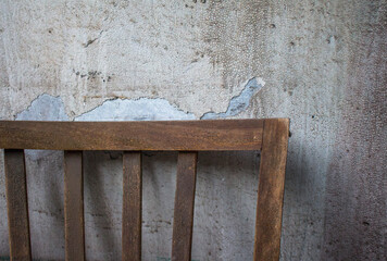old wooden chair against a shabby wall 