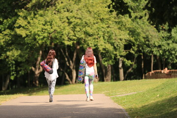 two girl  walking in the park