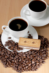 Cup of coffee and sweet cookies on a wooden kitchen table