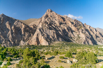 Fototapeta na wymiar The beautiful mountain trekking road with clear blue sky and rocky hills in Fann mountains in Tajikistan