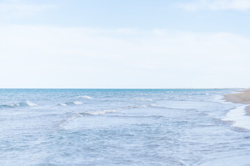Side of the beach without people, with some small waves to make it beautiful.
