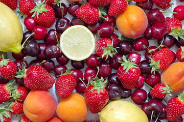 Directly above shot of various fruit - strawberries, cherries, apricot, lemon