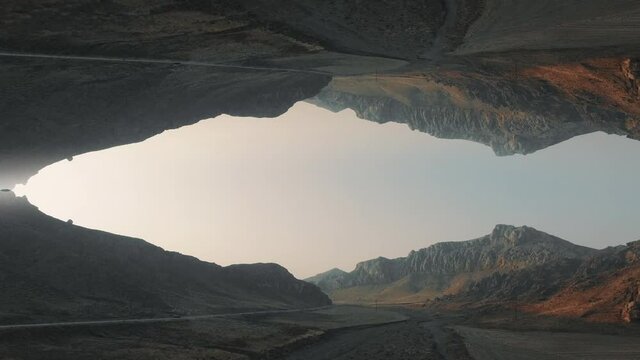 Trippy surreal 4k drone footage of dry hills  early in the morning.