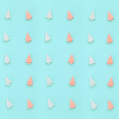 Pastel cute candy sweets, in form of Christmas trees. New Year pattern in mint pink tones on paper...