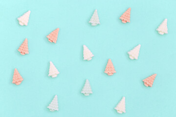 Small sweet marshmallows in shape of Christmas trees. Color candy creative for New Year or...