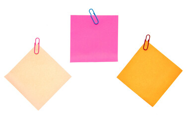 Colored pieces of paper with paper clips on a white background.