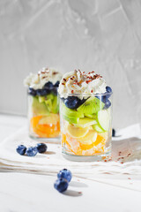 Healthy fruit salad snack with whipped cream