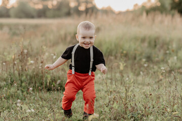 happy cute little baby boy smiling in autumn field