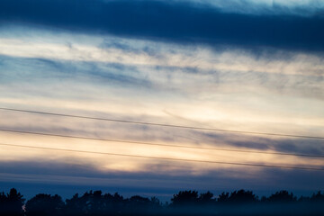 Fototapeta premium Sunset colored sky, blue, yellow, orange and red, mixed colors,shadows and lights