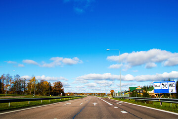 Highway landscape in Europe, street and sings on the road.Blue sky and daylight