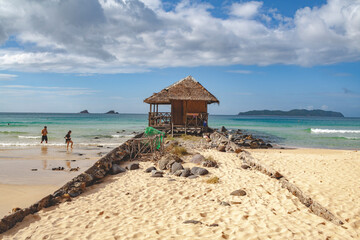 Remote wooden building on the beach of Nacpan, El Nido, Philippines