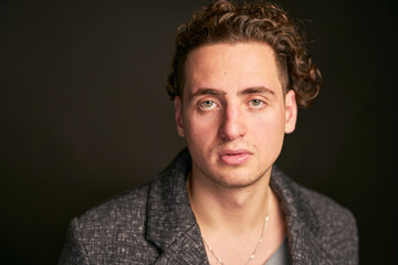 Obraz premium Headshots of young man with green eyes and curly hair