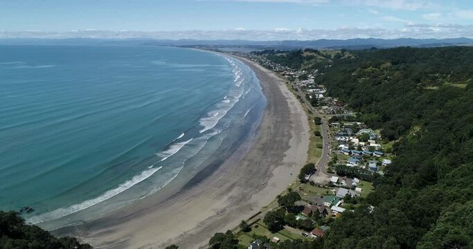 4k aerial hovering stationary motion above the popular tourist beach of Ohope Beach, known as one of the top beaches on the North Island of New zealand