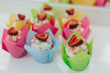 sweet cupcakes muffins with fresh strawberries and white cream