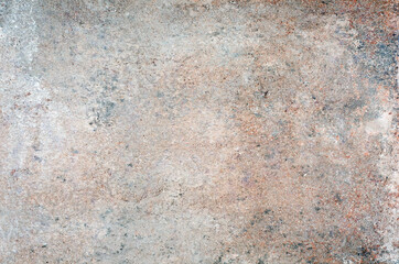 Rough stone texture with colored spots.