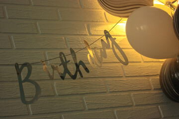 Birthday balloons: black and white balloons against a white brick wall background