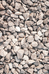 Vertical gravel texture for background. Small pebble road. Granite shape.