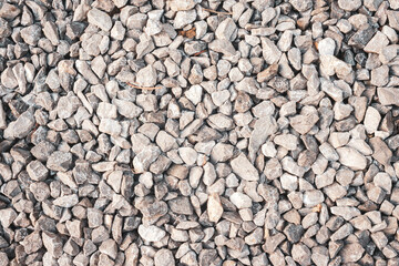 White and grey gravel texture in garden. Pebble background.