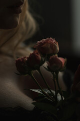 View of the female neck, collarbone and shoulders with flowers, close-up, silhouette